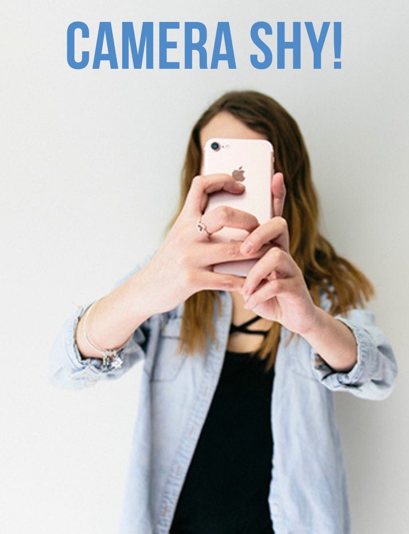 Woman holding phone in front of face with text "photo coming soon"