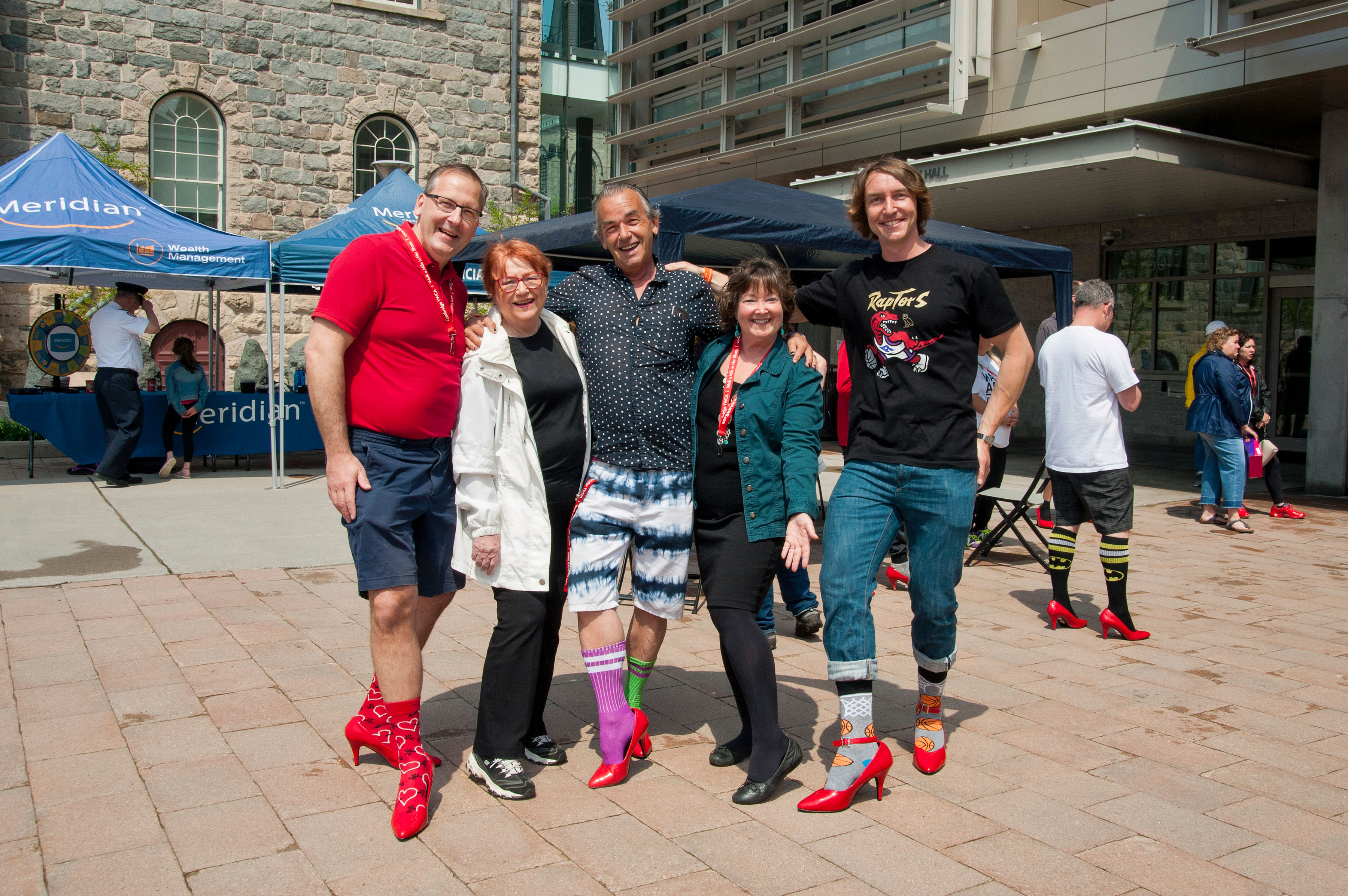 group of people in red high heels at city hall