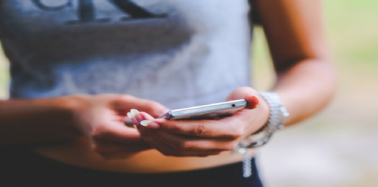 Image of a woman's hands holding cellphone.