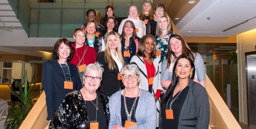 All 2019 Women of Distinction nominees stand together on a stairwell at Cambridge City Hall