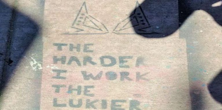 Sidewalk art "the harder I work the lukier I am"