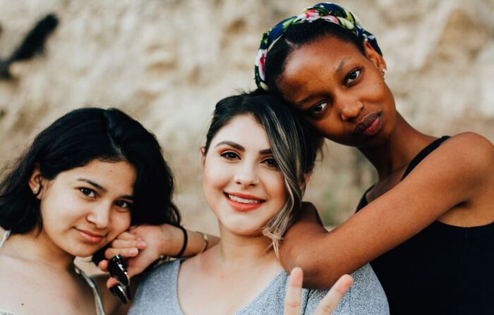 Three women smiling at camera