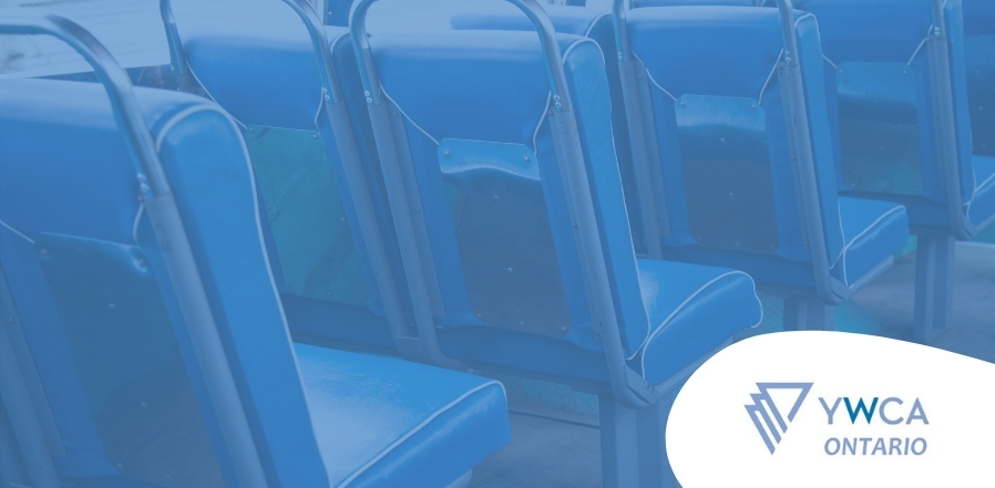 Close up of the seating inside a bus with a blue filter overlaying the image. The YWCA Ontario logo in on the bottom right corner.