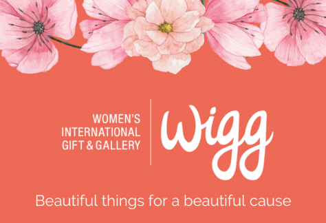 Coral background with pink pastel flowers and WIGG logo (Women's International Gift & Gallery) and tagline that reads Beautiful Things For A Beautiful Cause