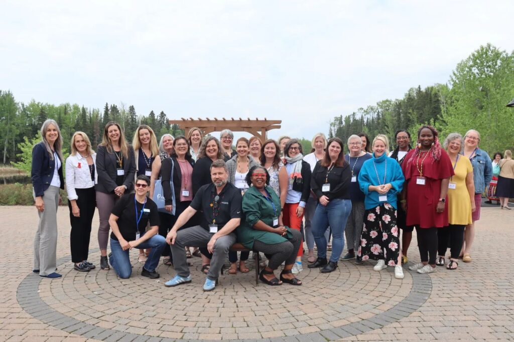 Photo taken outside on a brick patio. It features CEOs and EDs from YWCAs across Canada.