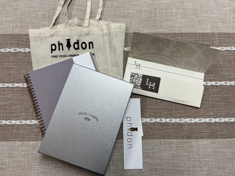 auction package with notebooks and stationary