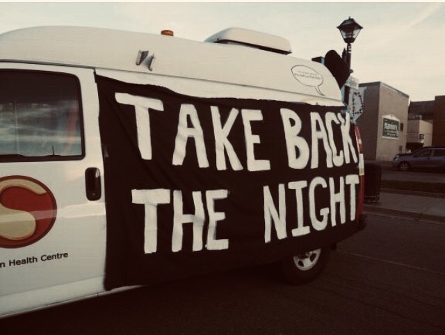 Take Back the Night Banner on the Sanguen street team van