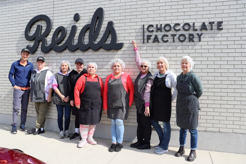 Jodi (third from right) stands with some of her Reid's teammates outside of the Elgin St. location