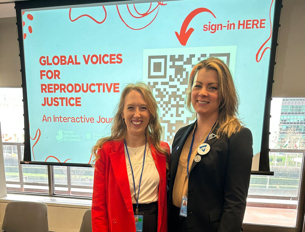 Roz (right) stands with YWCA Toronto Interim Director of Communications and Advocacy, Sami Pritchard, at YWCA Canada's session on reproductive justice.