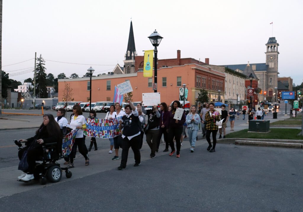 A group of TBTN 2023 participants marching down Dickson Street