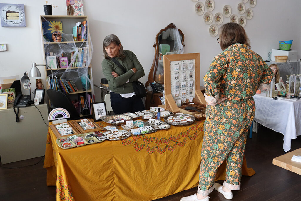 A vendor at the 2023 Feminist Night market with all of their products displayed for sale