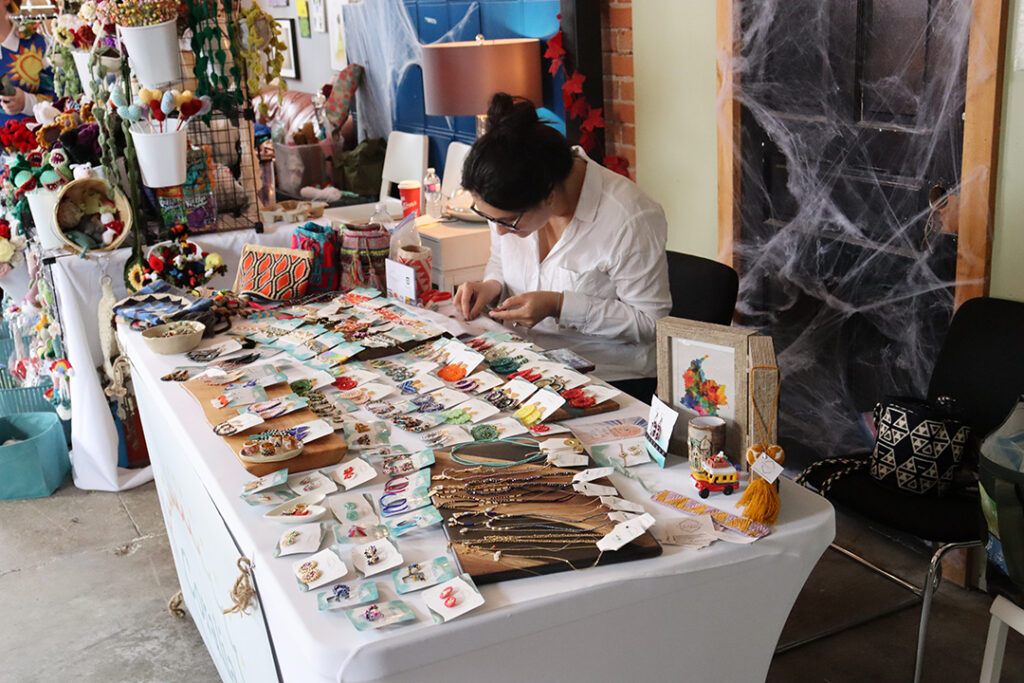 A vendor at the 2023 Feminist Night market with all of their products displayed for sale