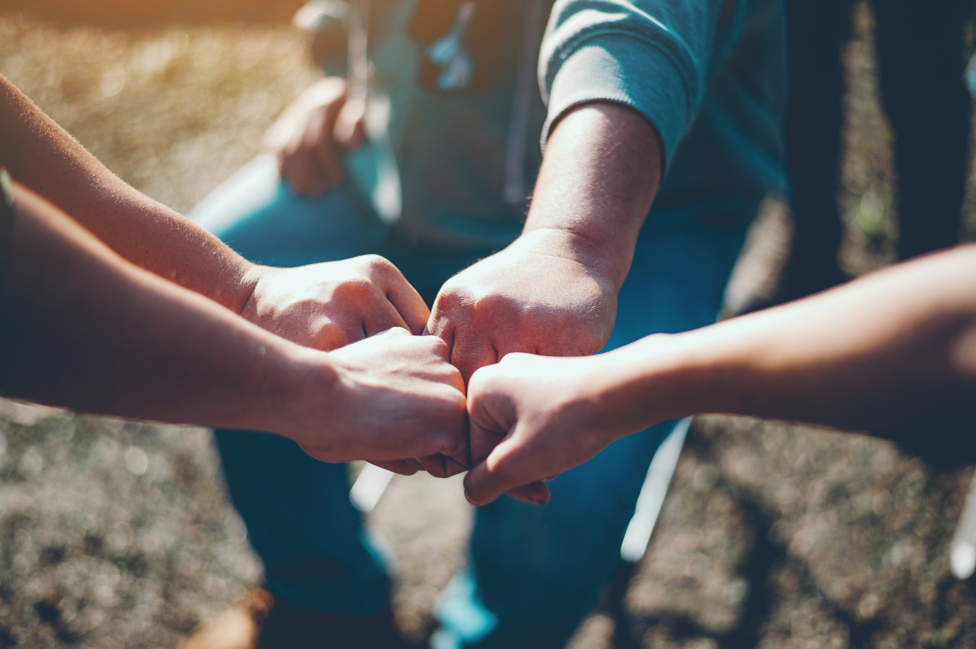 A group of hands "fist bumping"