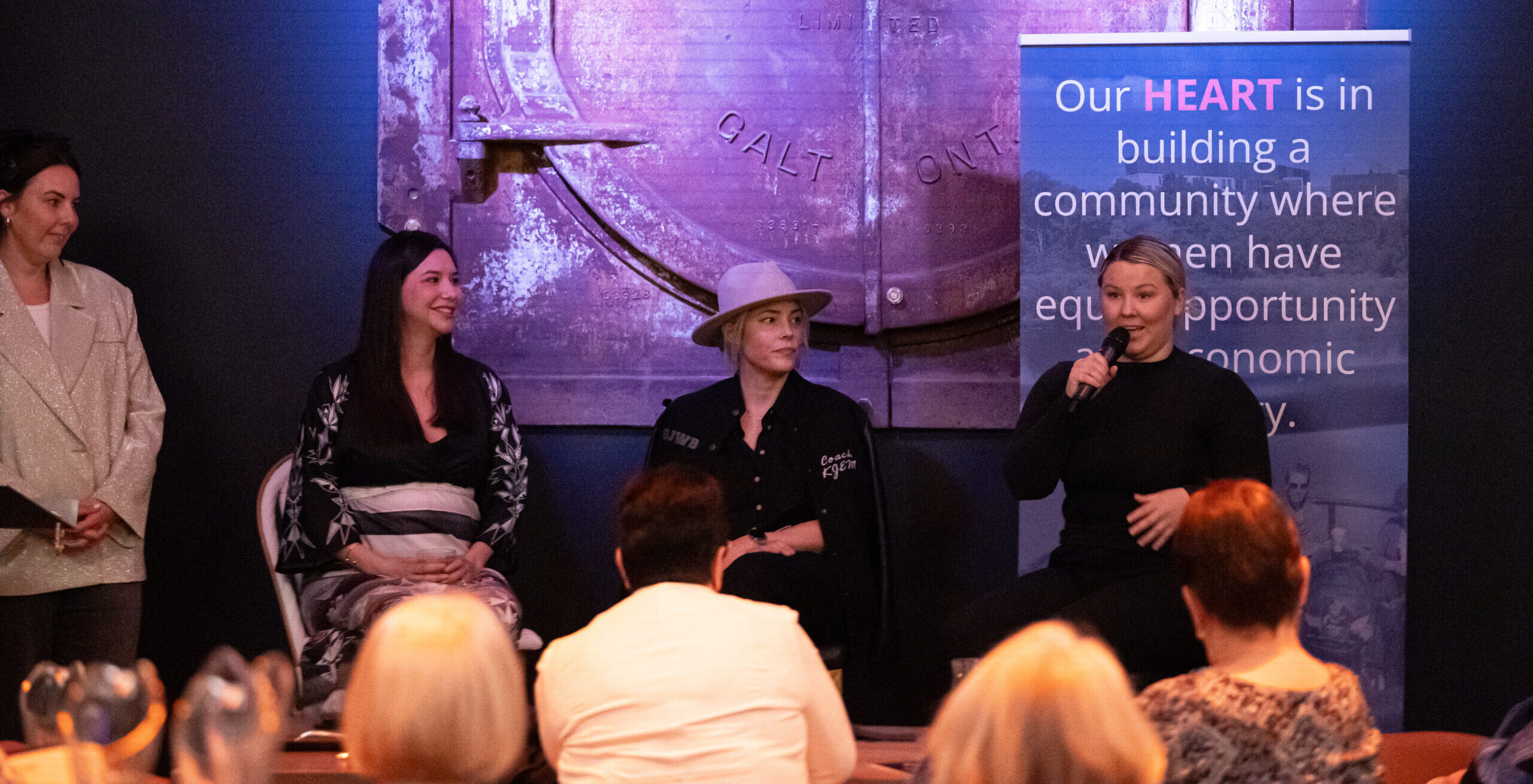 a photo of the 2024 She Talks event speakers, all sitting on the stage at The Underwing