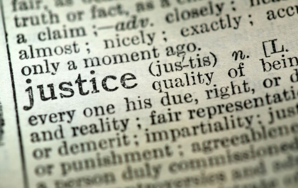 Close-up of the dictionary definition of "justice"
