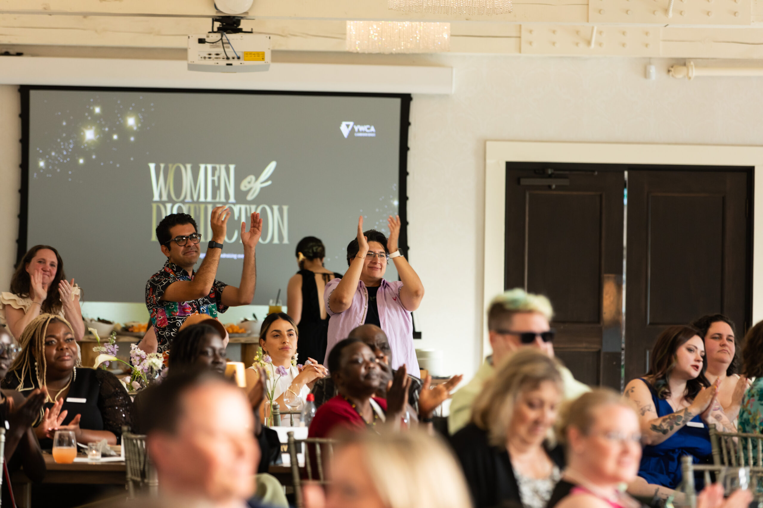 a group of people celebrating award winners at the women of distinction event