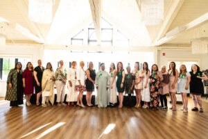 group of of 21 women back lit by the sun
