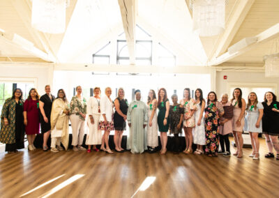 group of of 21 women back lit by the sun